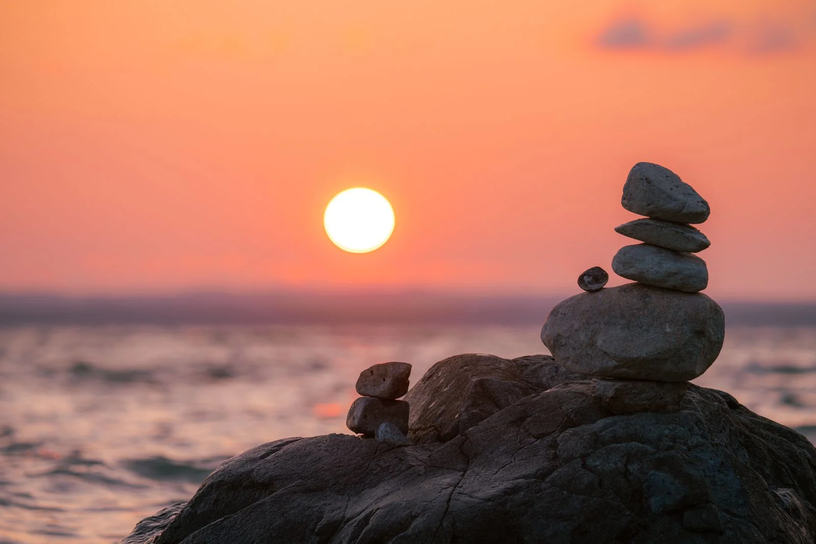Gebalanceerde stenen bij zonsondergang die rechtvaardigheid symboliseren