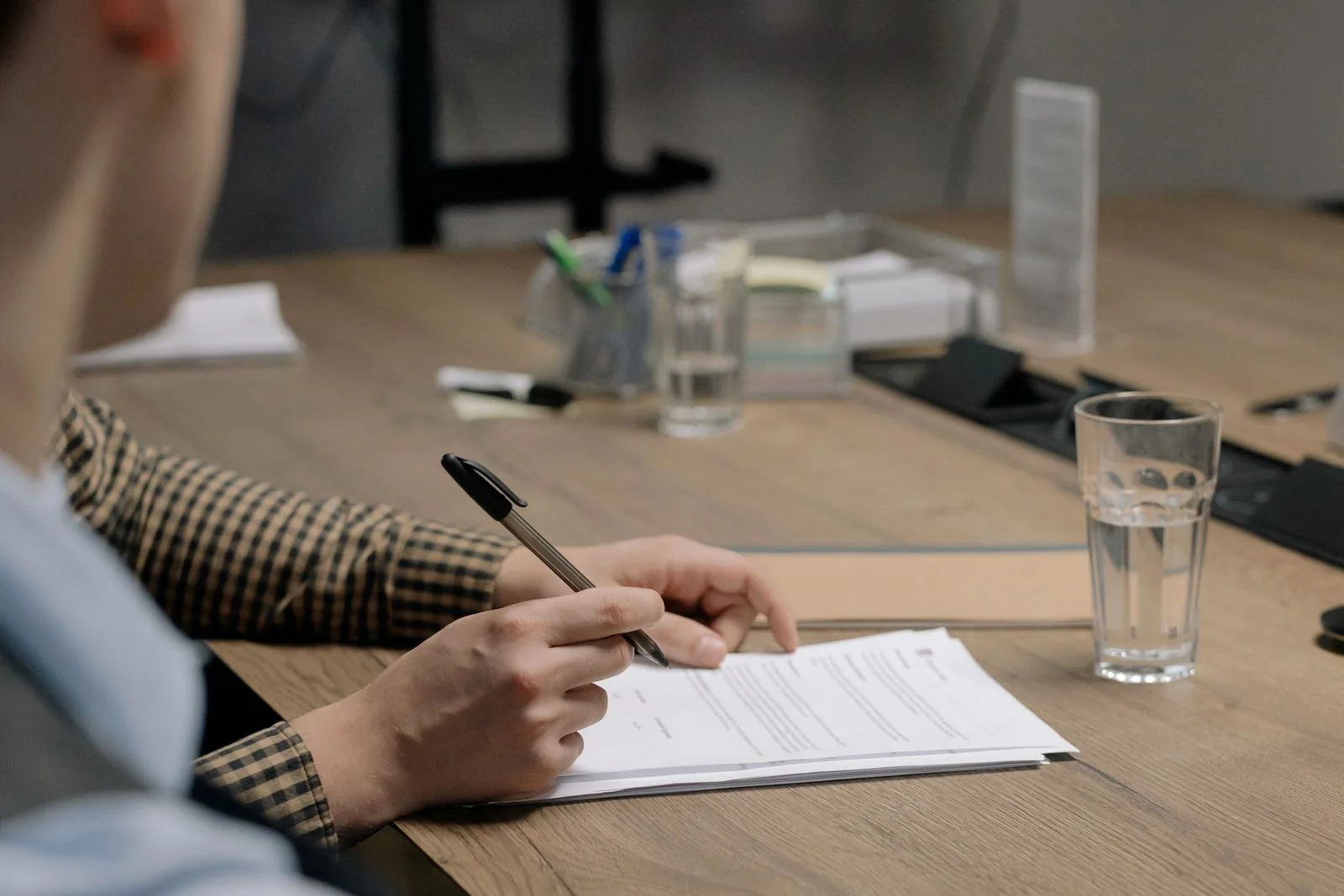 Hands signing a document
