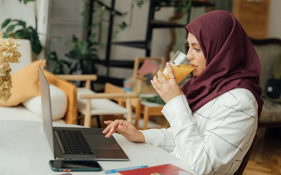 Modern Muslim businesswoman working at a laptop